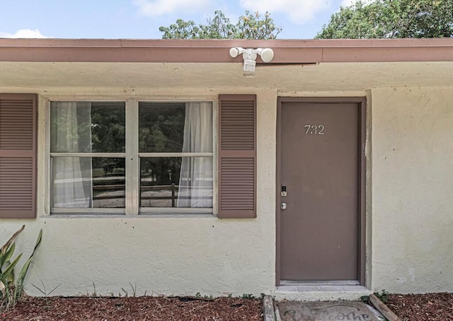 732 Neil Rd Unit 1-4, West Palm Beach, FL 33415 - doorway to property with stucco siding