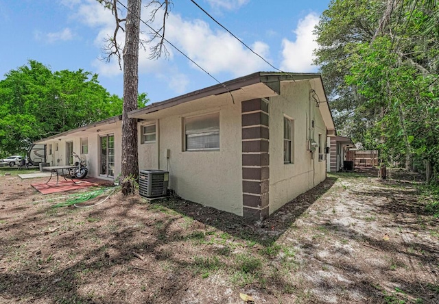 732 Neil Rd Unit 1-4, West Palm Beach, FL 33415 - view of property exterior featuring stucco siding and a patio