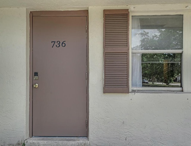 732 Neil Rd Unit 1-4, West Palm Beach, FL 33415 - doorway to property featuring stucco siding
