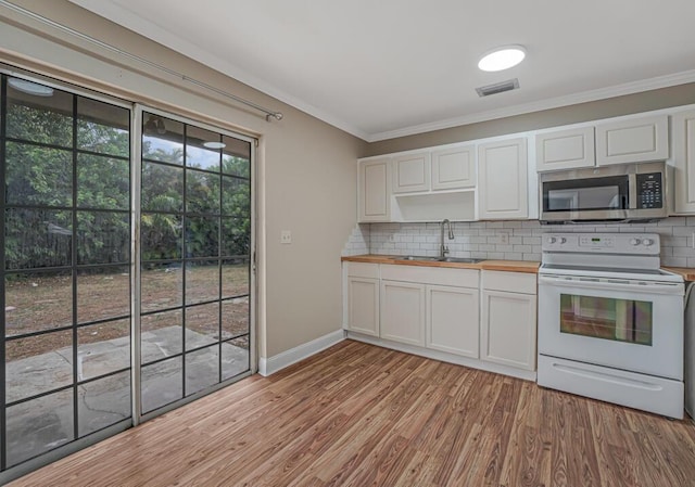 732 Neil Rd Unit 1-4, West Palm Beach, FL 33415 - kitchen with stainless steel microwave, white range with electric cooktop, butcher block countertops, ornamental molding, and decorative backsplash