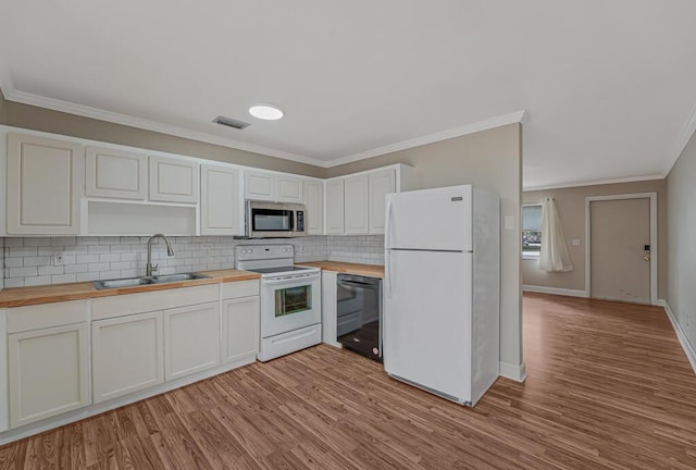 732 Neil Rd Unit 1-4, West Palm Beach, FL 33415 - kitchen featuring wood counters, white appliances, ornamental molding, tasteful backsplash, and light wood-type flooring