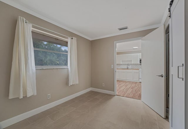 732 Neil Rd Unit 1-4, West Palm Beach, FL 33415 - empty room featuring crown molding and a barn door