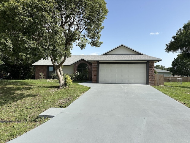 226 SW Statler Ave, Port Saint Lucie, FL 34984 - ranch-style house with a garage, driveway, and brick siding