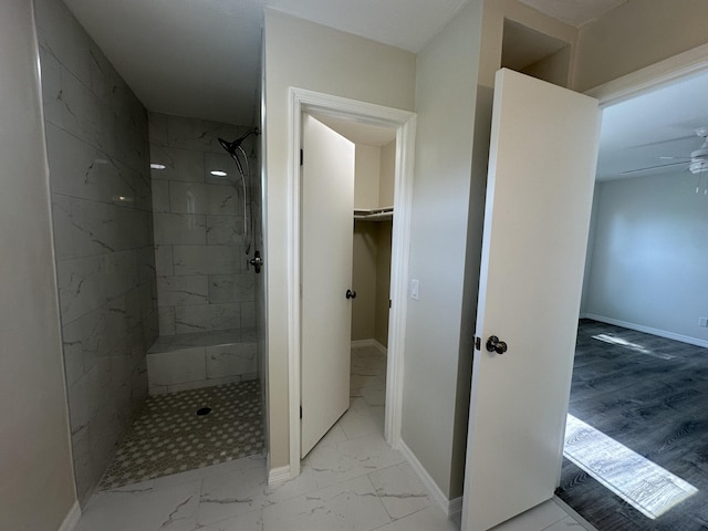 226 SW Statler Ave, Port Saint Lucie, FL 34984 - bathroom featuring marble finish floors, tiled shower, a ceiling fan, and a spacious closet