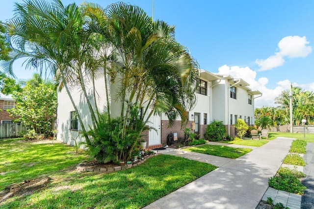 421 N Cypress Dr Unit 15, Tequesta, FL 33469 - view of front facade with stucco siding and brick siding