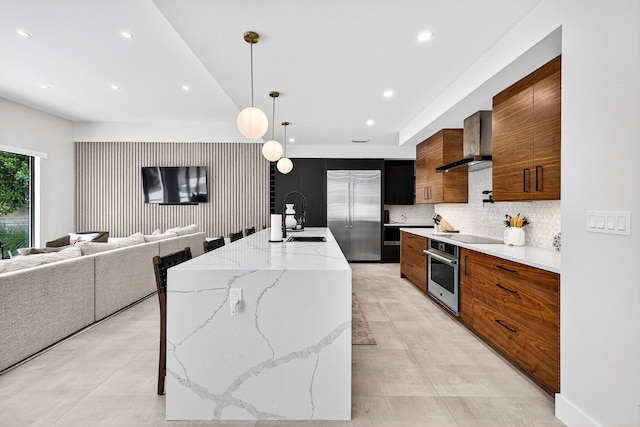 1807 NE 18th St, Fort Lauderdale, FL 33305 - kitchen with stainless steel appliances, wall chimney range hood, modern cabinets, recessed lighting, and decorative backsplash