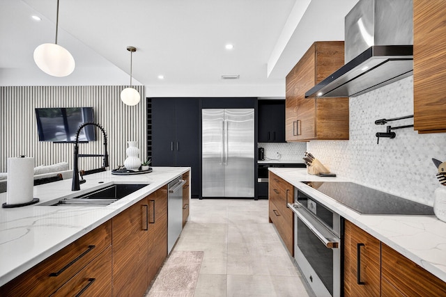 1807 NE 18th St, Fort Lauderdale, FL 33305 - kitchen with stainless steel appliances, wall chimney range hood, brown cabinetry, modern cabinets, and recessed lighting