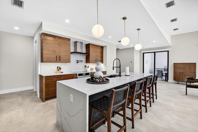 1807 NE 18th St, Fort Lauderdale, FL 33305 - kitchen featuring wall chimney exhaust hood, modern cabinets, brown cabinets, tasteful backsplash, and recessed lighting