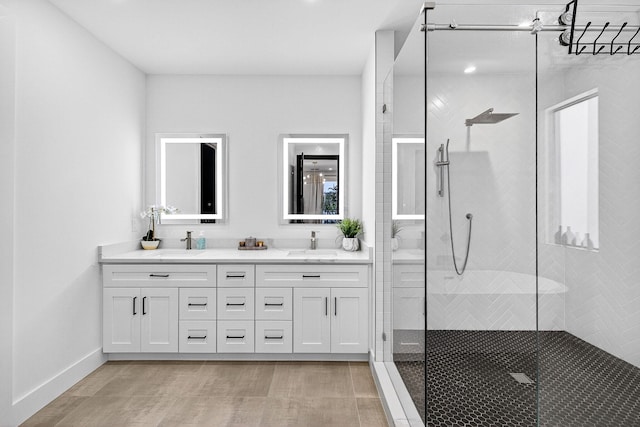 1807 NE 18th St, Fort Lauderdale, FL 33305 - bathroom featuring double vanity, walk in shower, and wood finished floors
