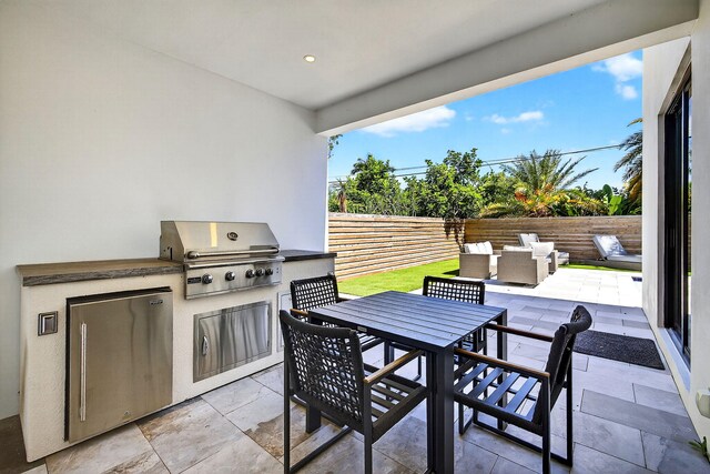 1807 NE 18th St, Fort Lauderdale, FL 33305 - fenced backyard featuring area for grilling, a patio, and outdoor dining space