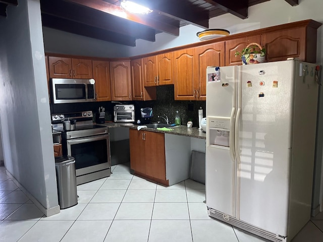 9940 SW 48th St, Miami, FL 33165 - kitchen with appliances with stainless steel finishes, beamed ceiling, light tile patterned floors, brown cabinets, and backsplash