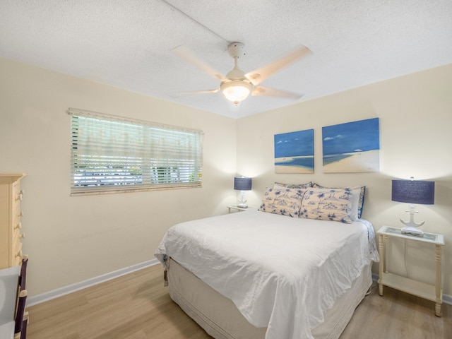 52 Yacht Club Dr Unit 103, North Palm Beach, FL 33408 - bedroom with wood finished floors, a textured ceiling, and a ceiling fan