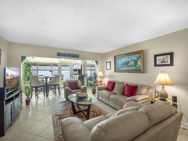 52 Yacht Club Dr Unit 103, North Palm Beach, FL 33408 - living area featuring light tile patterned floors and a textured ceiling