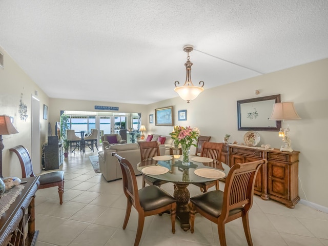 52 Yacht Club Dr Unit 103, North Palm Beach, FL 33408 - dining area with a textured ceiling and light tile patterned floors