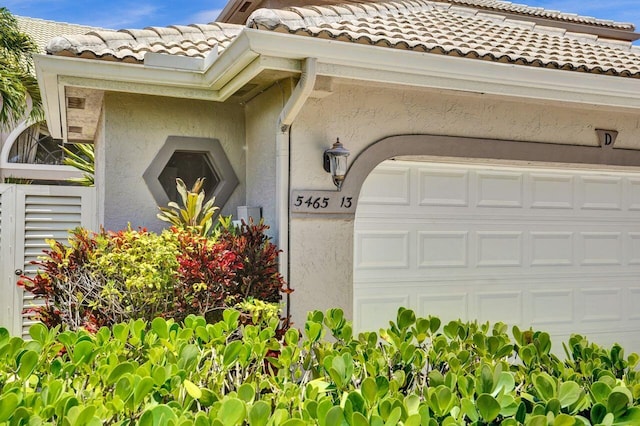 5465 Monterey D Cir Unit D, Delray Beach, FL 33484 - entrance to property featuring stucco siding, a tile roof, and a garage