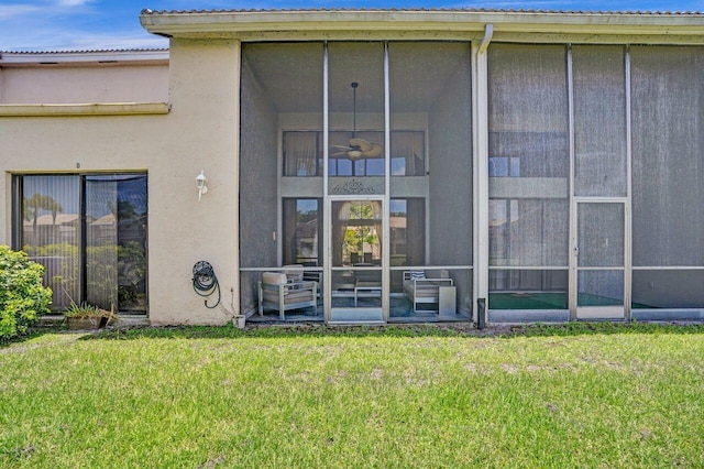5465 Monterey D Cir Unit D, Delray Beach, FL 33484 - rear view of property featuring a sunroom, a yard, and a metal roof