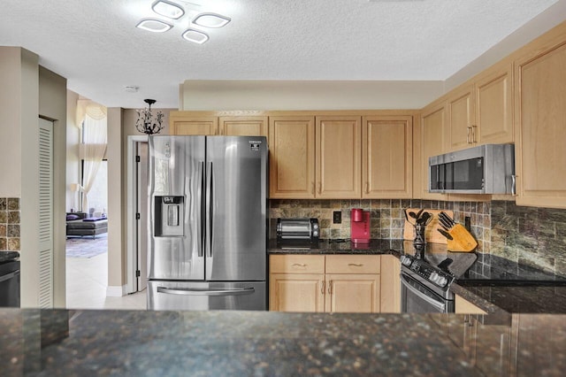 5465 Monterey D Cir Unit D, Delray Beach, FL 33484 - kitchen with appliances with stainless steel finishes, light brown cabinetry, tasteful backsplash, a textured ceiling, and dark stone counters