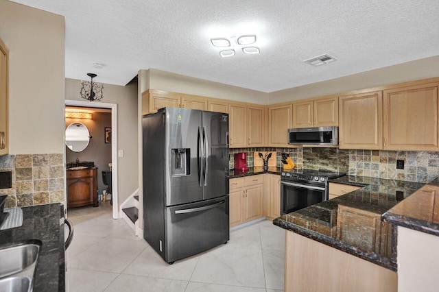 5465 Monterey D Cir Unit D, Delray Beach, FL 33484 - kitchen with appliances with stainless steel finishes, light brown cabinets, tasteful backsplash, and a textured ceiling