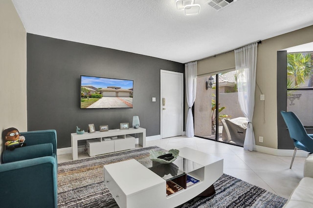 5465 Monterey D Cir Unit D, Delray Beach, FL 33484 - tiled living area featuring a textured ceiling and baseboards