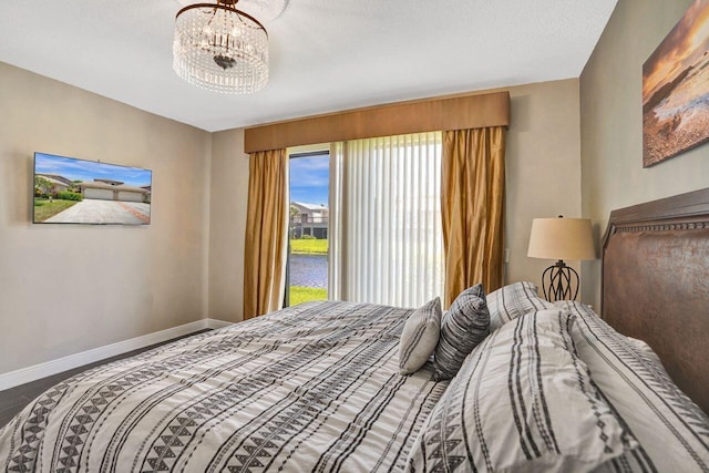 5465 Monterey D Cir Unit D, Delray Beach, FL 33484 - bedroom featuring a chandelier and a water view