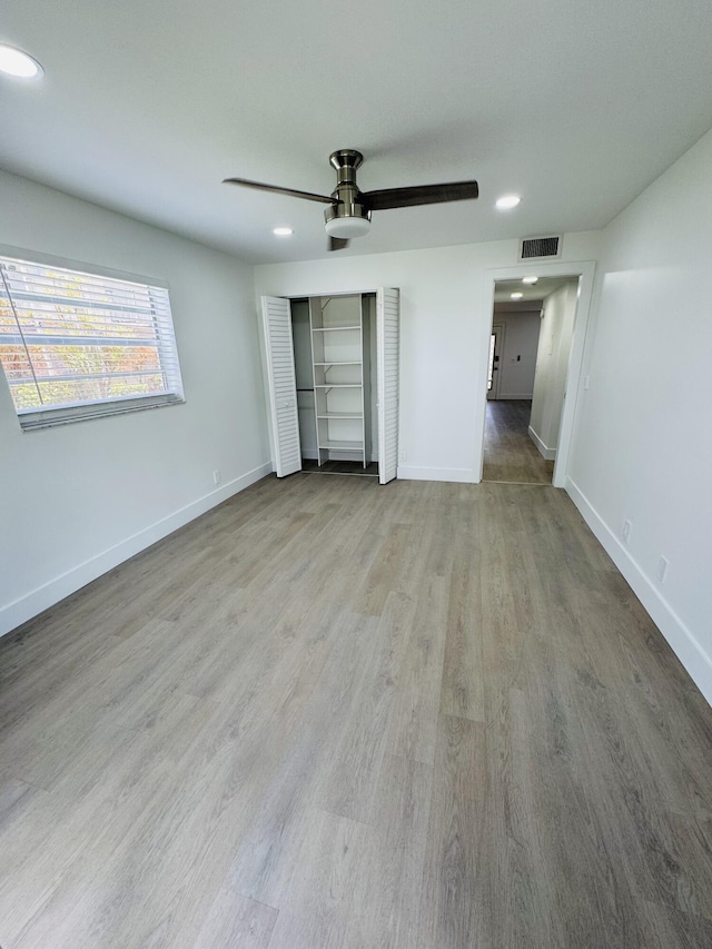 970 Normandy U, Delray Beach, FL 33484 - unfurnished bedroom featuring wood finished floors, recessed lighting, a closet, and ceiling fan