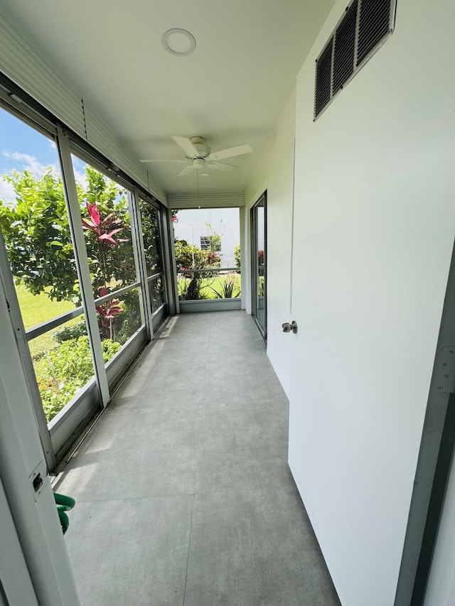 970 Normandy U, Delray Beach, FL 33484 - unfurnished sunroom with a ceiling fan and plenty of natural light
