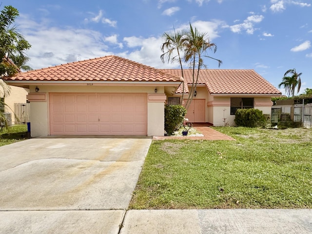5825 Laurel Green Cir, Boynton Beach, FL 33437 - mediterranean / spanish house featuring stucco siding, driveway, a front yard, a garage, and a tiled roof