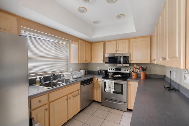 2860 Sheriff Way, Winter Park, FL 32792 - kitchen with stainless steel appliances, light brown cabinets, a tray ceiling, and light tile patterned flooring