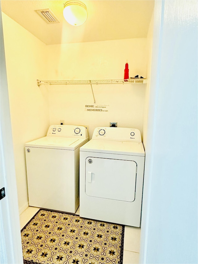 6455 NW Foxglove St, Port Saint Lucie, FL 34986 - laundry room with washing machine and dryer and light tile patterned floors
