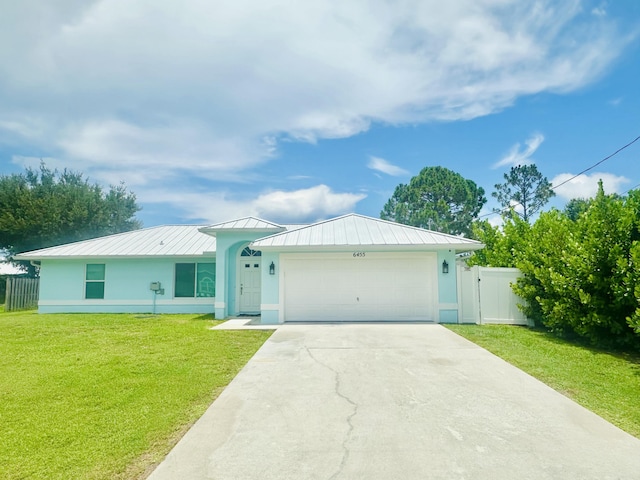 6455 NW Foxglove St, Port Saint Lucie, FL 34986 - ranch-style house with a standing seam roof, a garage, concrete driveway, and a metal roof