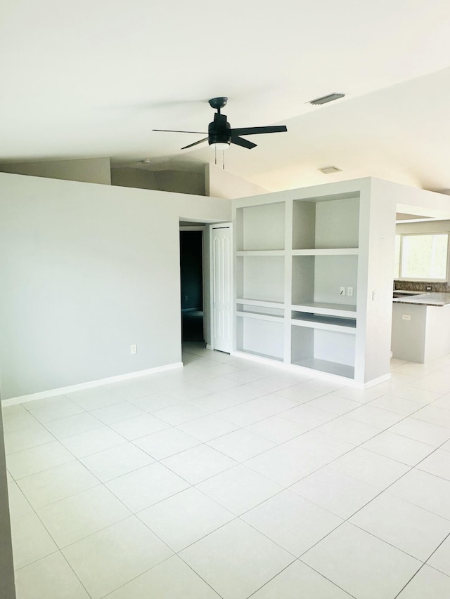 6455 NW Foxglove St, Port Saint Lucie, FL 34986 - spare room featuring a ceiling fan, vaulted ceiling, light tile patterned floors, and built in features