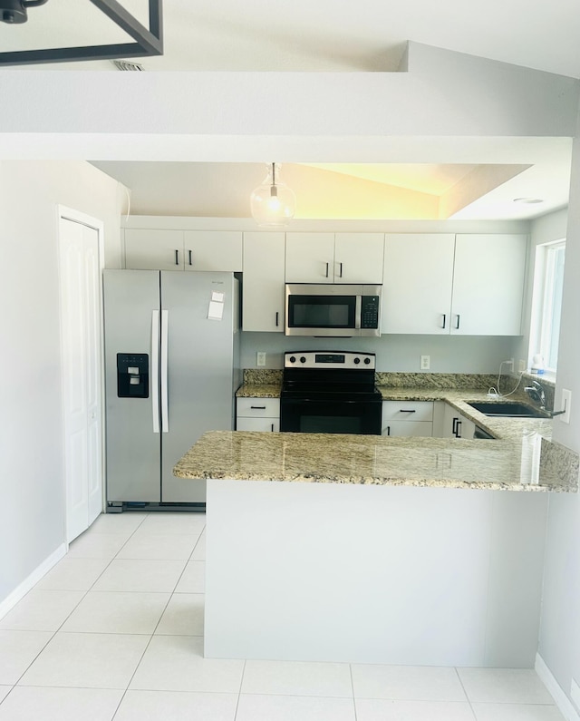 6455 NW Foxglove St, Port Saint Lucie, FL 34986 - kitchen featuring appliances with stainless steel finishes, a peninsula, light stone countertops, and white cabinetry