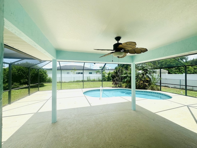 6455 NW Foxglove St, Port Saint Lucie, FL 34986 - view of swimming pool with glass enclosure, a patio area, and a ceiling fan
