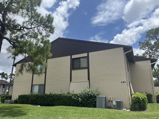 441 Pine Glen Ln Unit B1, Greenacres, FL 33463 - view of property exterior with stucco siding and a yard