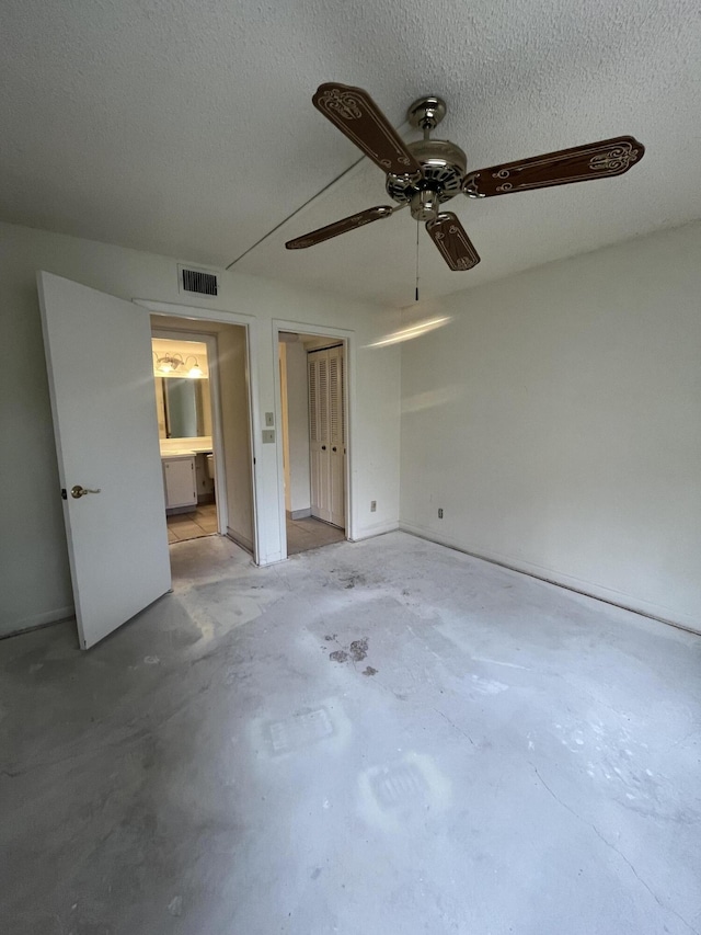 441 Pine Glen Ln Unit B1, Greenacres, FL 33463 - unfurnished bedroom featuring concrete floors and a ceiling fan