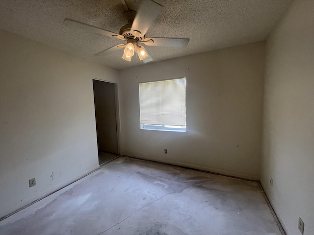 441 Pine Glen Ln Unit B1, Greenacres, FL 33463 - unfurnished room with unfinished concrete floors, ceiling fan, and a textured ceiling