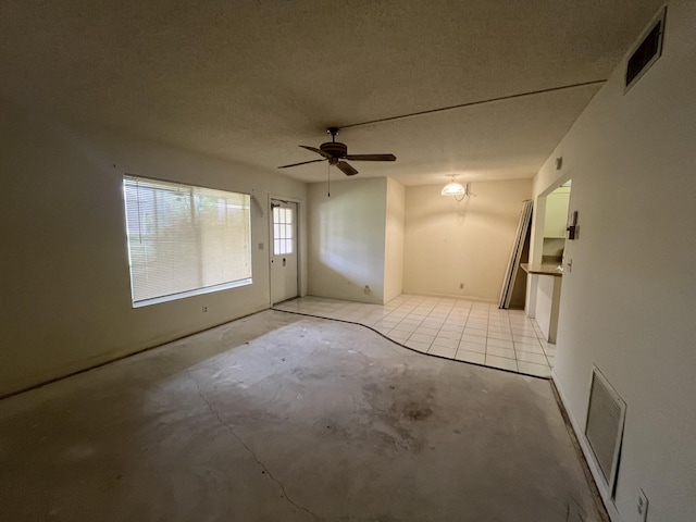 441 Pine Glen Ln Unit B1, Greenacres, FL 33463 - unfurnished room with a ceiling fan, a textured ceiling, and unfinished concrete flooring