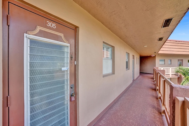 9700 Sunrise Lakes Blvd Unit 305, Sunrise, FL 33322 - view of exterior entry with a balcony and stucco siding