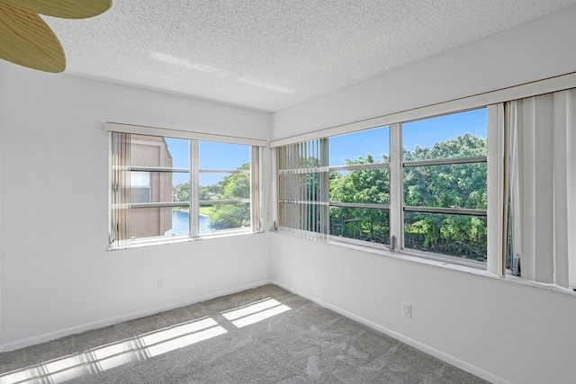 9700 Sunrise Lakes Blvd Unit 305, Sunrise, FL 33322 - carpeted spare room featuring a textured ceiling and baseboards