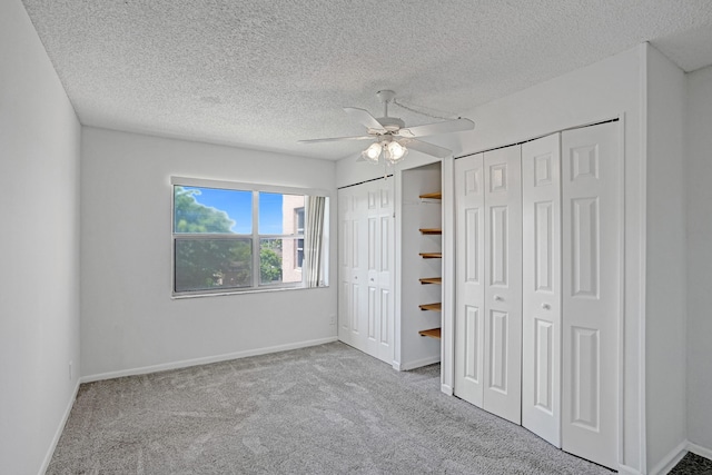 9700 Sunrise Lakes Blvd Unit 305, Sunrise, FL 33322 - unfurnished bedroom with multiple closets, carpet flooring, a textured ceiling, and a ceiling fan