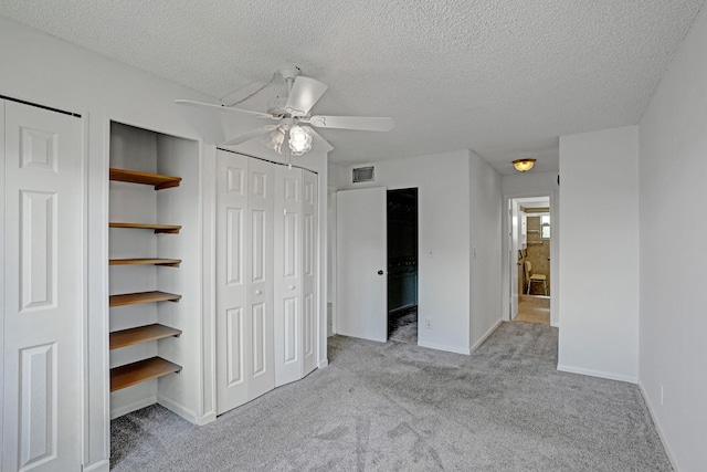 9700 Sunrise Lakes Blvd Unit 305, Sunrise, FL 33322 - unfurnished bedroom with a textured ceiling, carpet floors, two closets, a ceiling fan, and ensuite bathroom