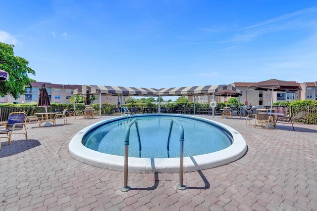 9700 Sunrise Lakes Blvd Unit 305, Sunrise, FL 33322 - community pool featuring a residential view and a patio area