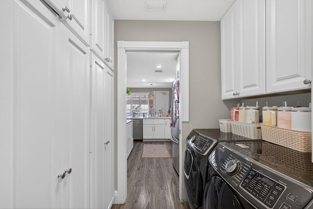 274 Murray Ct, Jupiter, FL 33458 - washroom with cabinet space, washer and clothes dryer, dark wood-style floors, and recessed lighting