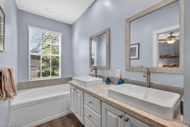 274 Murray Ct, Jupiter, FL 33458 - full bath with wood finished floors, double vanity, a garden tub, and a ceiling fan