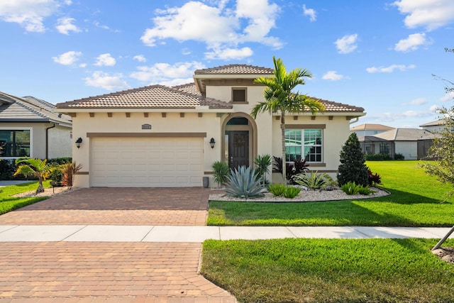 12136 SW Fortezza Way, Port Saint Lucie, FL 34987 - mediterranean / spanish-style house with stucco siding, decorative driveway, a front yard, a garage, and a tiled roof
