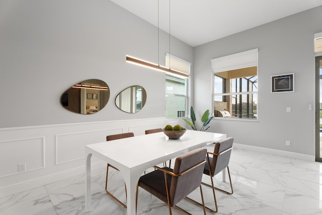 12136 SW Fortezza Way, Port Saint Lucie, FL 34987 - dining area with light marble finish flooring and a wainscoted wall