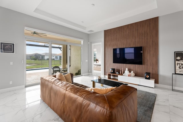 12136 SW Fortezza Way, Port Saint Lucie, FL 34987 - living area featuring a raised ceiling, light marble finish floors, and a ceiling fan