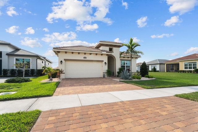 12136 SW Fortezza Way, Port Saint Lucie, FL 34987 - mediterranean / spanish house with decorative driveway, stucco siding, an attached garage, a front lawn, and a tile roof