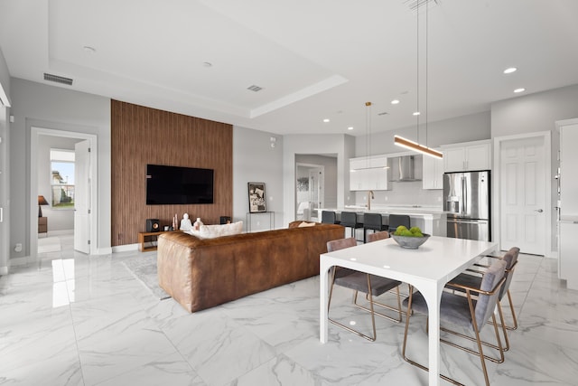 12136 SW Fortezza Way, Port Saint Lucie, FL 34987 - living area featuring light marble finish flooring, a raised ceiling, and recessed lighting