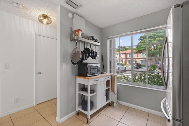 9931 Kamena Cir, Boynton Beach, FL 33436 - interior space featuring freestanding refrigerator, a textured ceiling, and a smoke detector